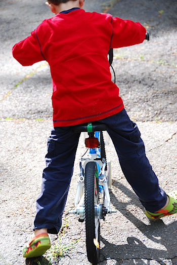 Child on bike pushing without pedals