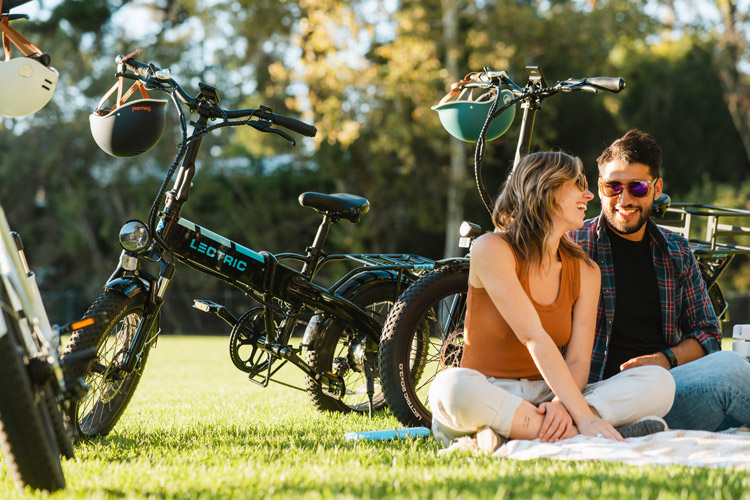 man and woman sitting next to lectric xp 3.0