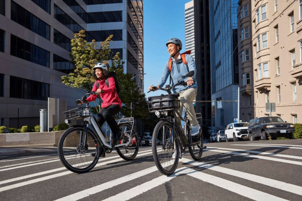 woman and man riding with new radcity 5 plus electric commuter bikes