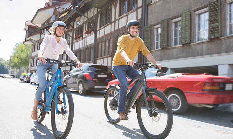 woman and man riding belt drive ebikes