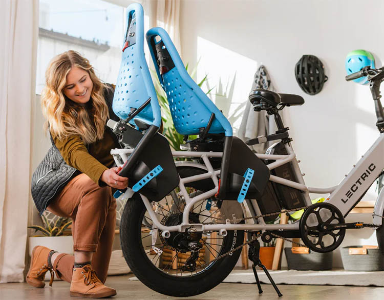 woman attaching two child seats on lectric xpedition