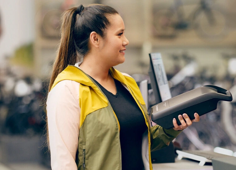 woman holding a replacement Bosch ebike battery