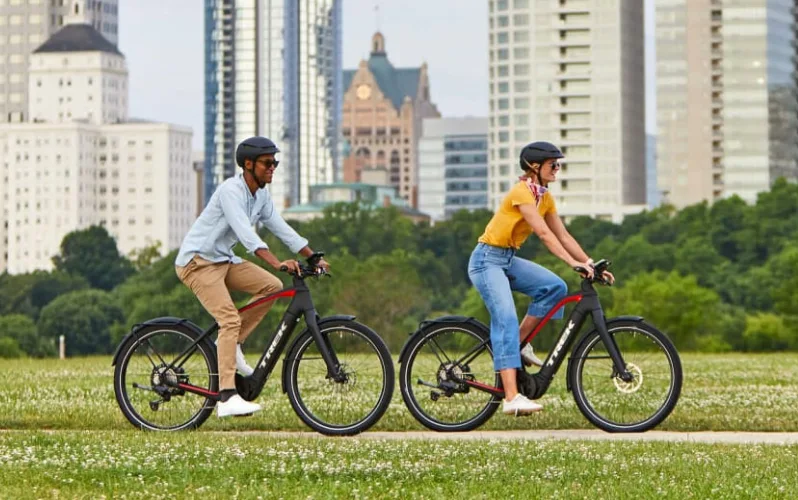 man and woman riding the Trek Allant+ commuter electric bike
