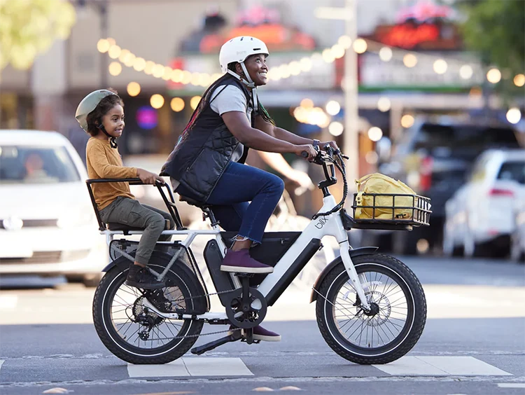 woman riding electric cargo bike