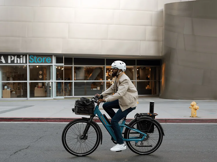 man riding a blue radster road electric bike