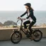 woman riding the Lectric ONE ebike along the coast