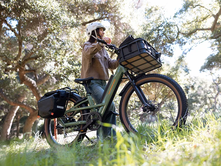 woman pushing a green radster trail electric bike